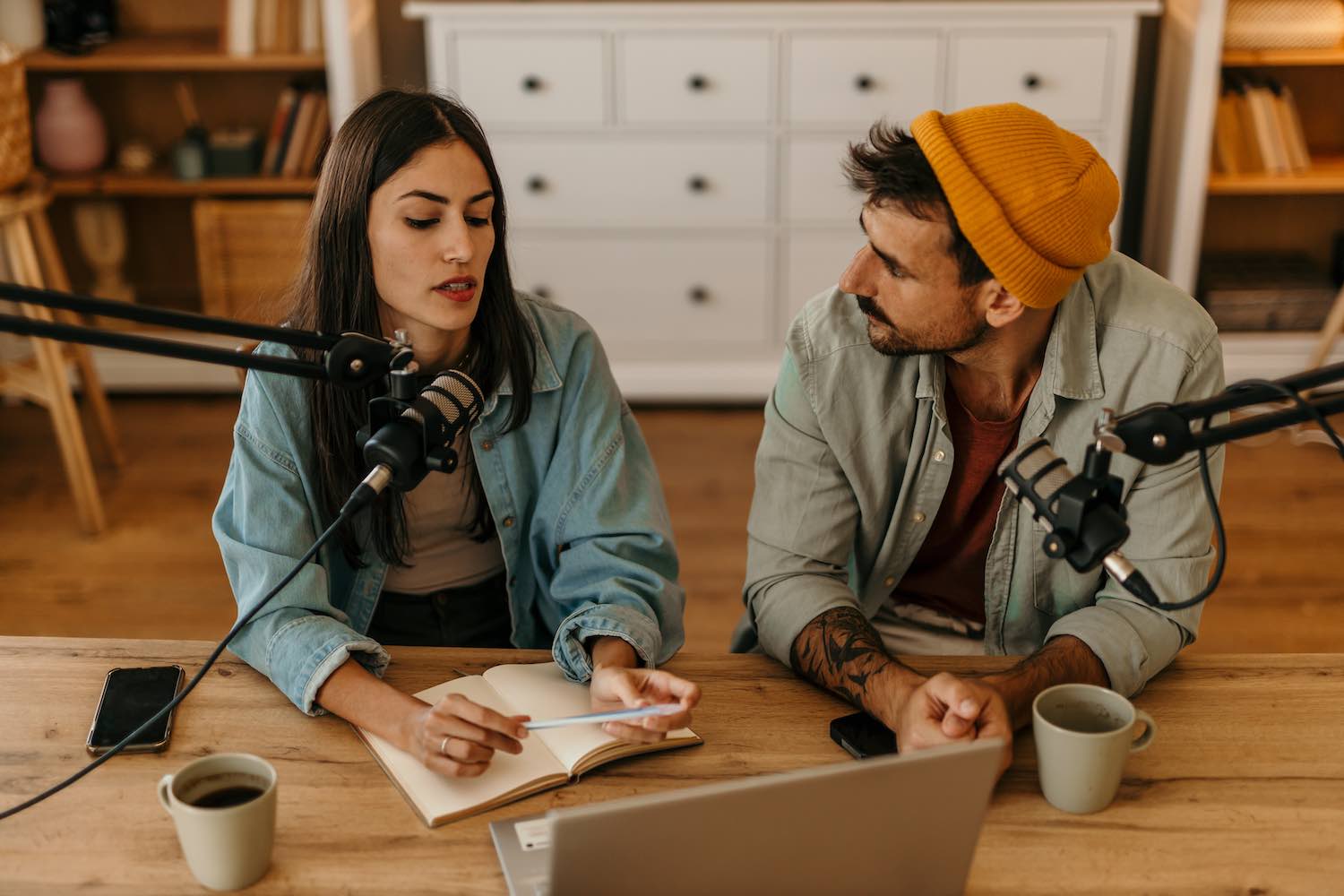 2 people writing a podcast script