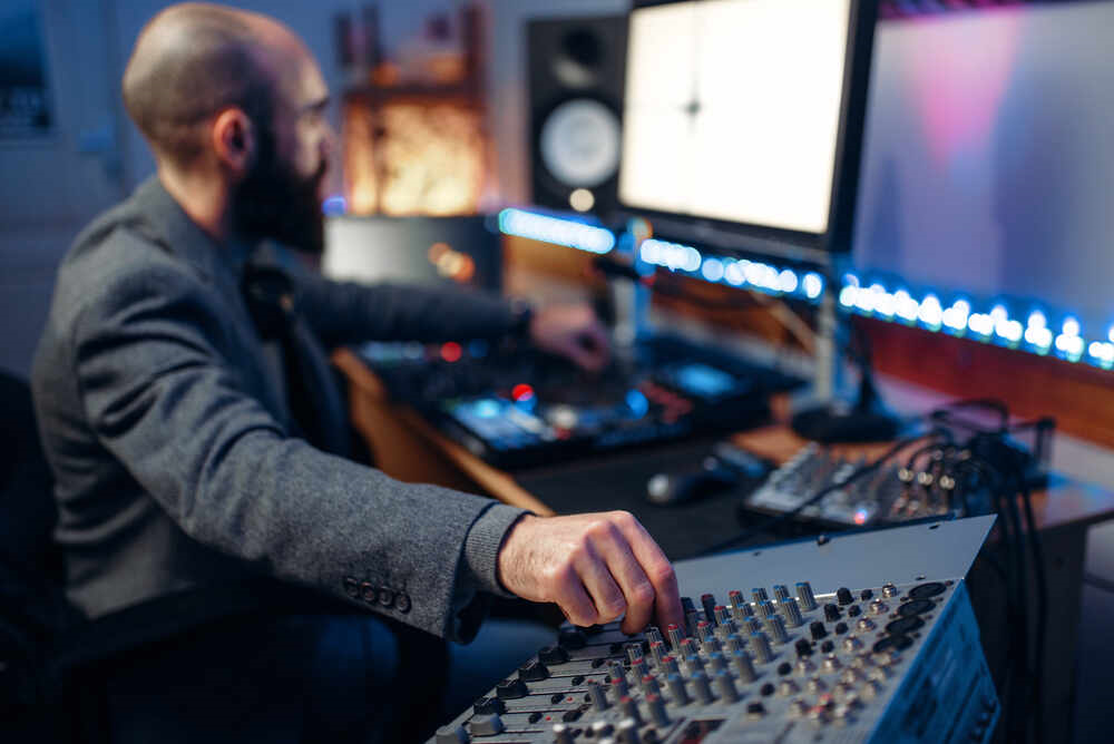 audio engineer operating a mixer