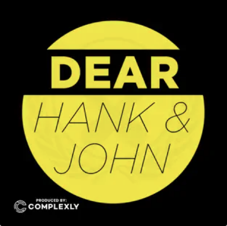 Dear Hank & John cover featuring a black background with a filled yellow circle with the title in black text.