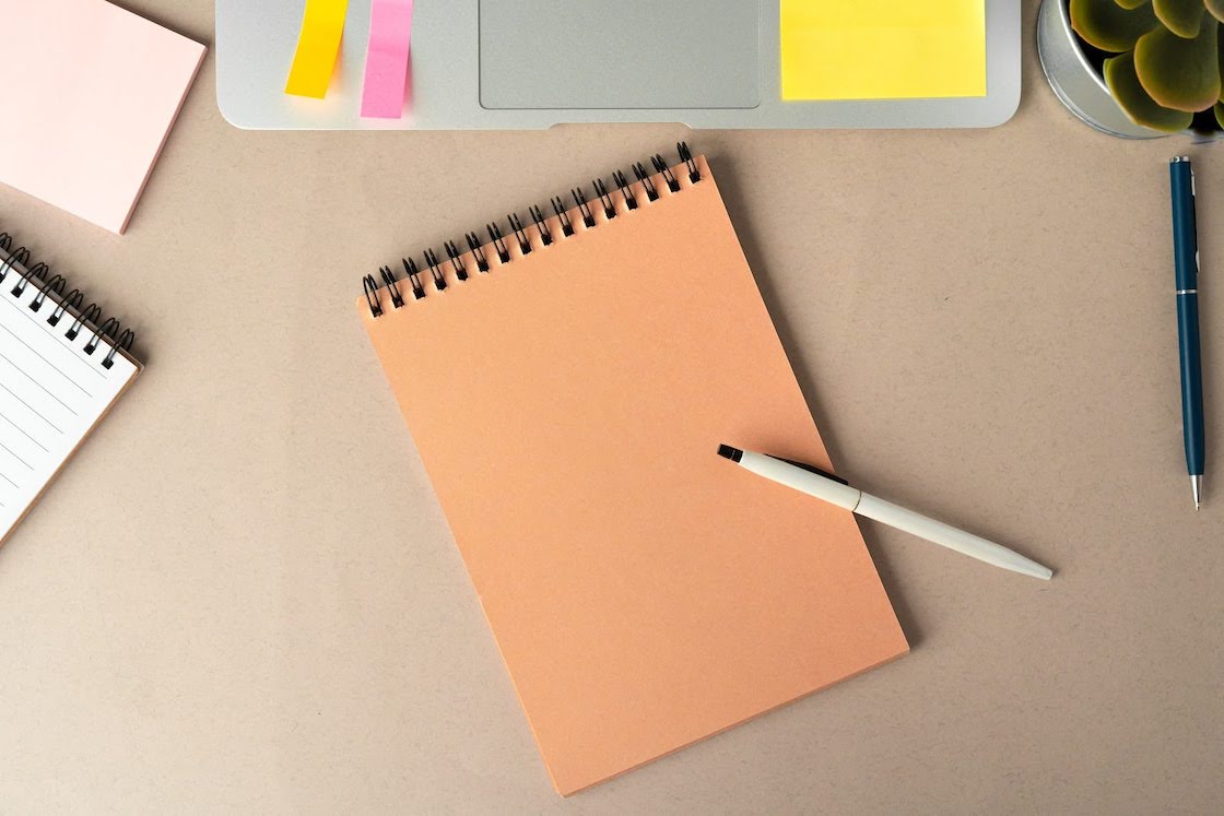 Image of a closed notebook on a desk