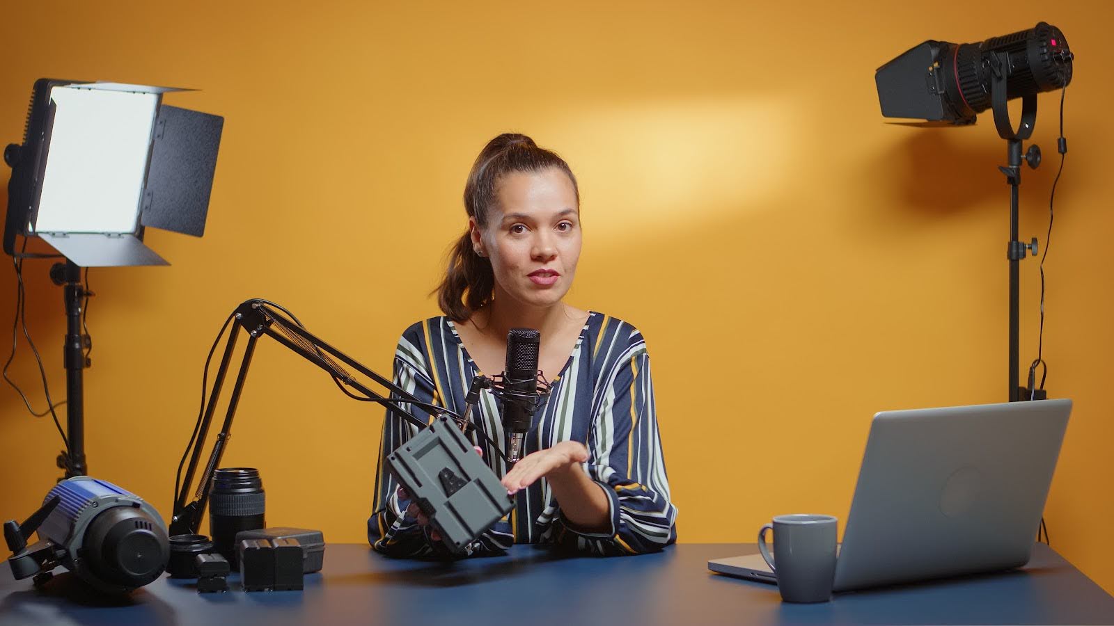 Image of a content creator recording a video with studio lighting. 